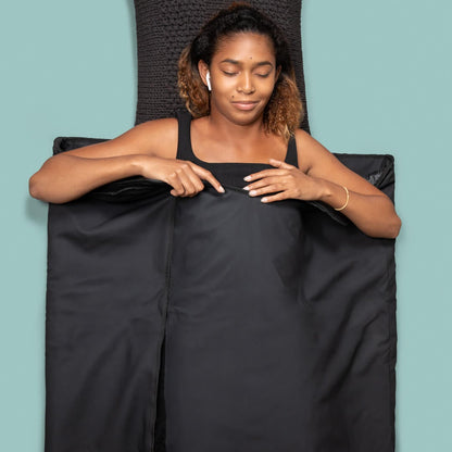 Young Young professional woman enjoying the relaxation from the infrared sauna blanket.